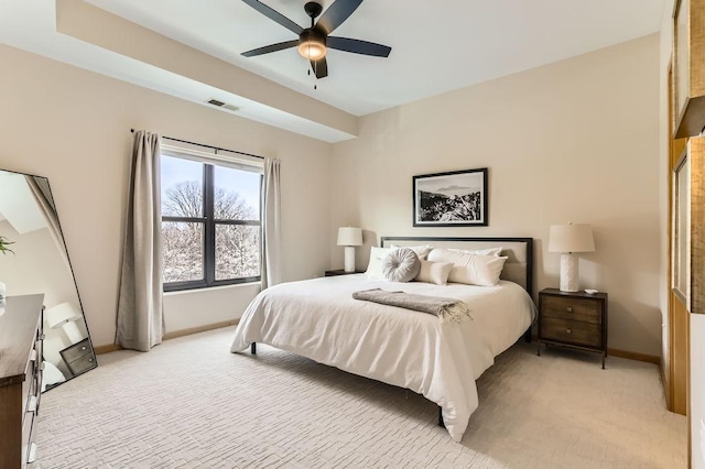 bedroom featuring a ceiling fan, visible vents, light colored carpet, and baseboards