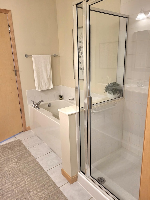 bathroom with tile patterned floors, a garden tub, and a stall shower