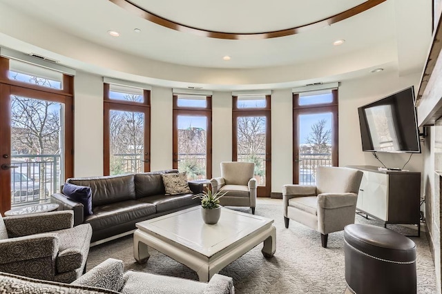 carpeted living room with plenty of natural light, recessed lighting, and visible vents