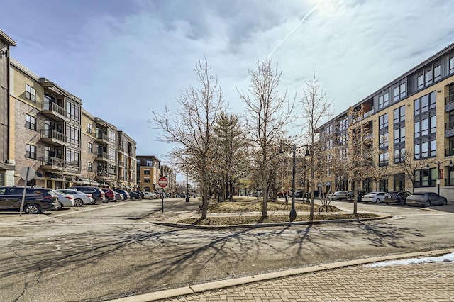 view of street featuring curbs, traffic signs, and sidewalks