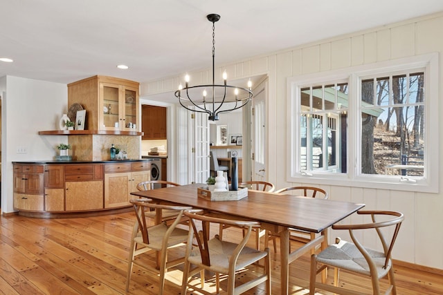 dining room with light wood-style floors, recessed lighting, washer / clothes dryer, and a chandelier