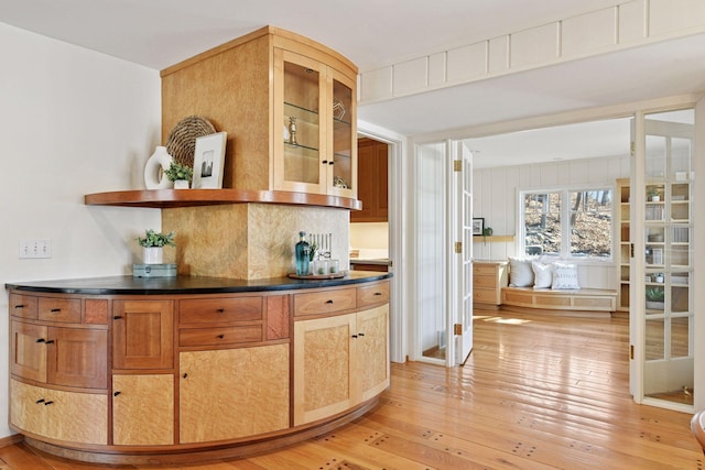 bar with backsplash and light wood-style flooring