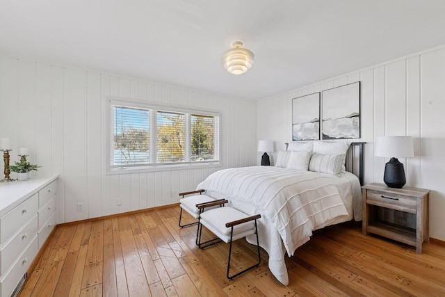 bedroom with light wood-style flooring and baseboards