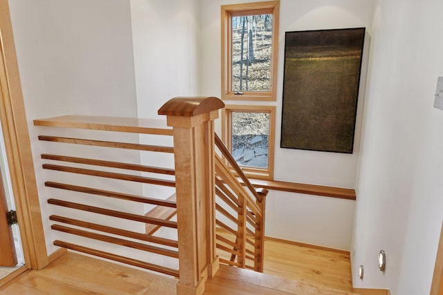 stairway featuring baseboards and wood finished floors