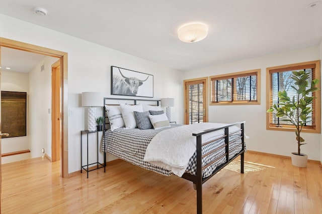 bedroom with light wood-style floors and baseboards