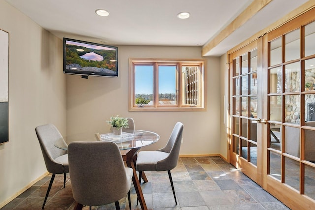 dining space with recessed lighting, stone finish flooring, plenty of natural light, and baseboards