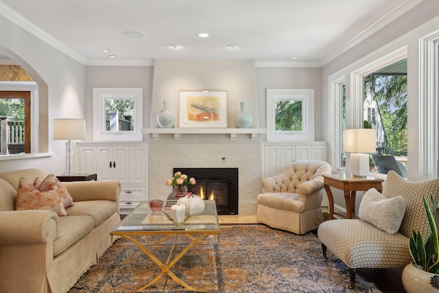 sitting room featuring ornamental molding, a fireplace, and a healthy amount of sunlight