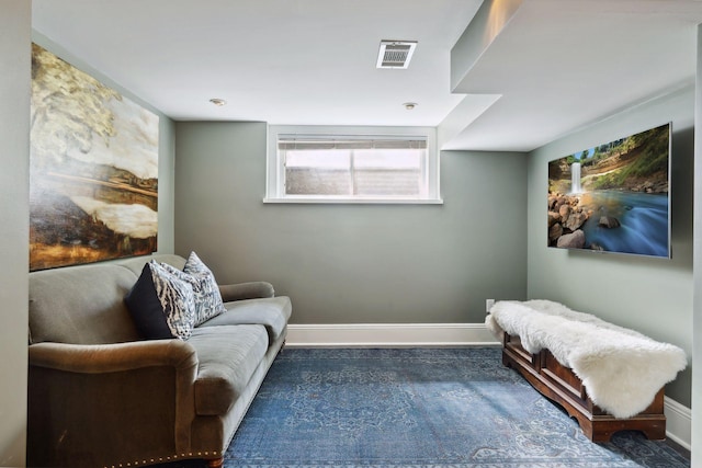 living area featuring visible vents and baseboards