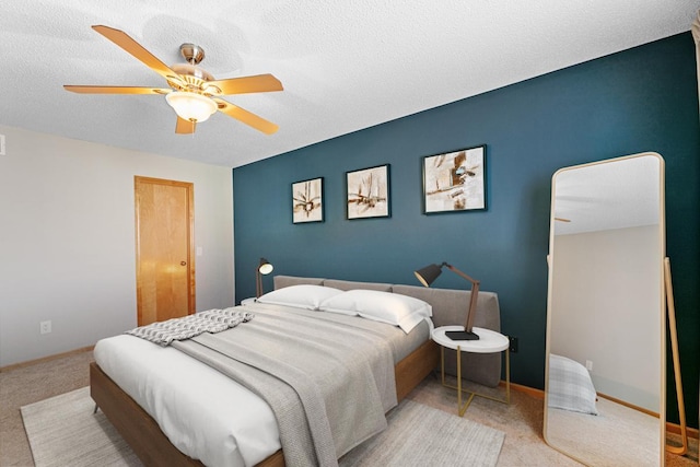 bedroom with baseboards, a textured ceiling, and a ceiling fan