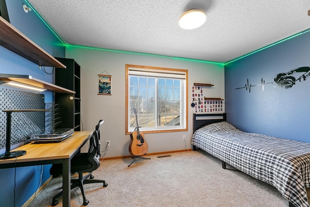 bedroom with carpet flooring, baseboards, and a textured ceiling