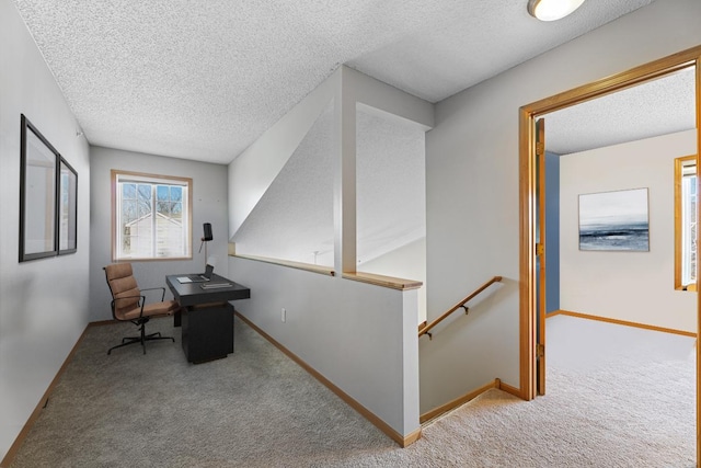 office with baseboards, a textured ceiling, and carpet flooring