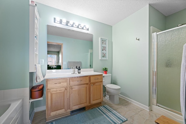 full bath featuring vanity, toilet, a stall shower, and a textured ceiling