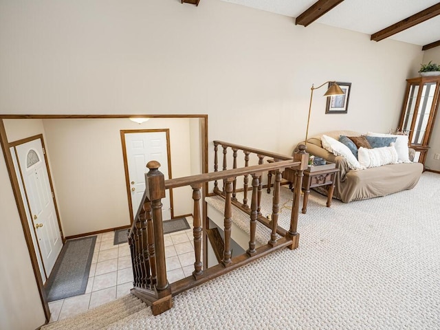 stairs featuring visible vents, carpet floors, beam ceiling, and tile patterned floors