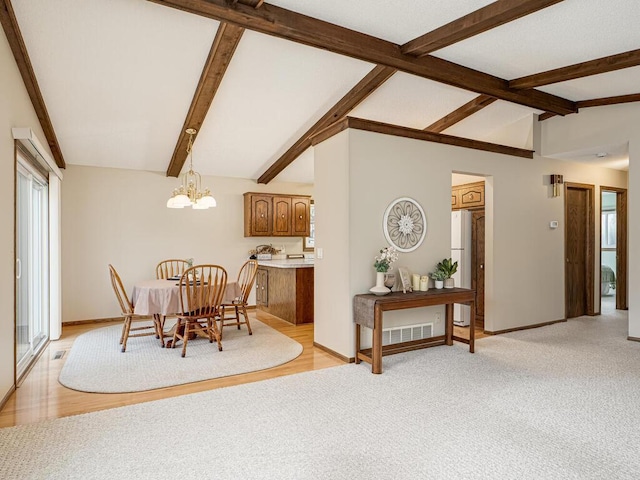 dining room with lofted ceiling with beams, a chandelier, light carpet, visible vents, and baseboards