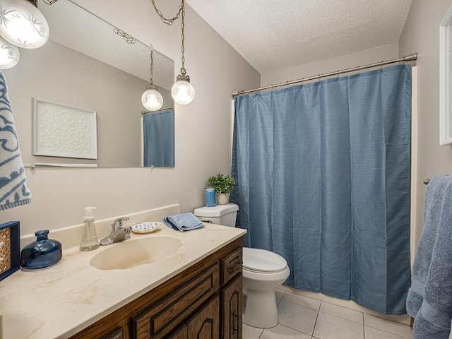 bathroom featuring tile patterned flooring, a textured ceiling, toilet, and vanity