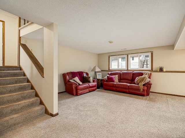 living room with stairs, a textured ceiling, carpet, and baseboards