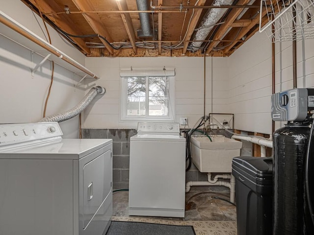 laundry area featuring laundry area, a sink, and separate washer and dryer