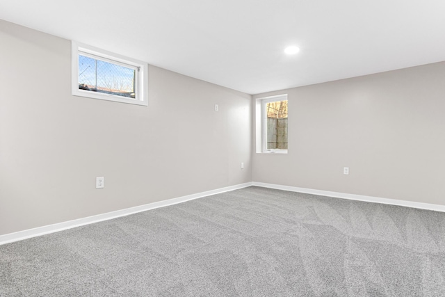 below grade area featuring carpet flooring, recessed lighting, and baseboards