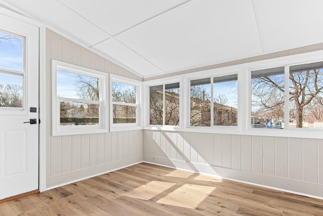 unfurnished sunroom featuring a healthy amount of sunlight and lofted ceiling