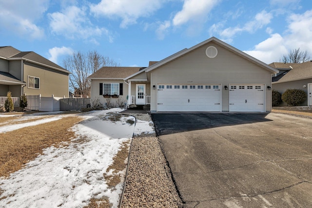 single story home featuring driveway, an attached garage, and fence