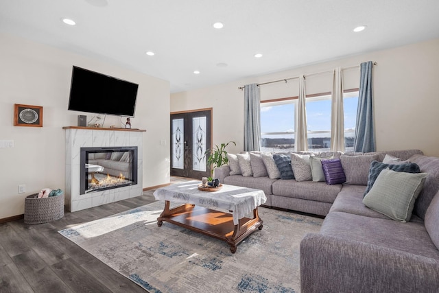 living room featuring recessed lighting, a fireplace, and wood finished floors