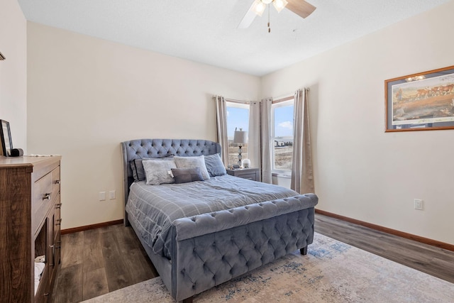 bedroom featuring wood finished floors, baseboards, and ceiling fan