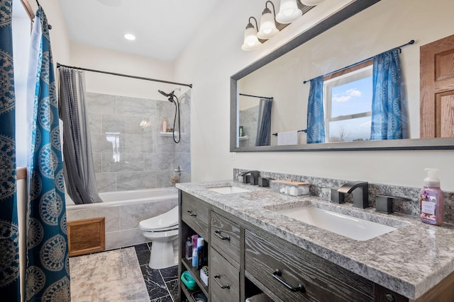 bathroom featuring a sink, tiled shower / bath, toilet, and double vanity