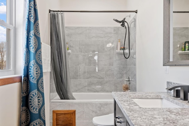 full bath featuring vanity, toilet, and tiled shower / bath combo