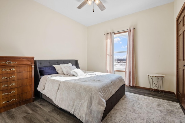 bedroom with baseboards, dark wood-style flooring, and ceiling fan