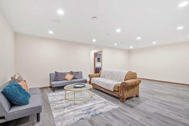 living room with recessed lighting, baseboards, and light wood-style floors