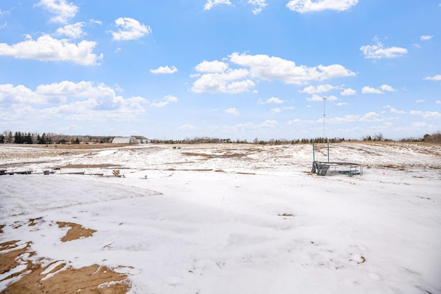 snowy yard with a rural view