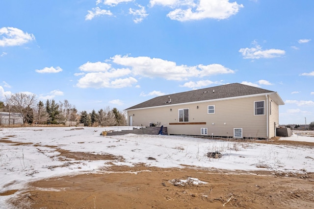 snow covered property with cooling unit