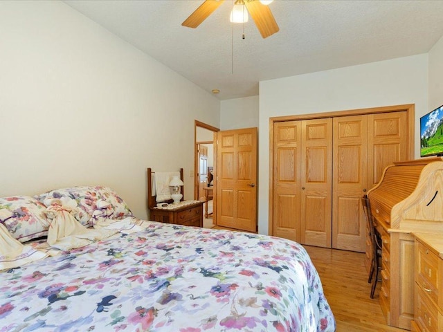 bedroom with a closet, ceiling fan, and light wood finished floors