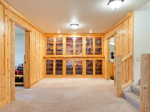 interior space featuring wooden walls and a textured ceiling