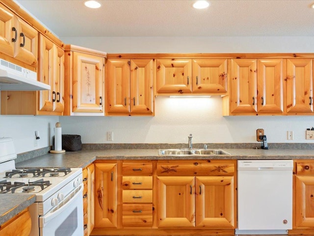 kitchen featuring white appliances, recessed lighting, under cabinet range hood, and a sink