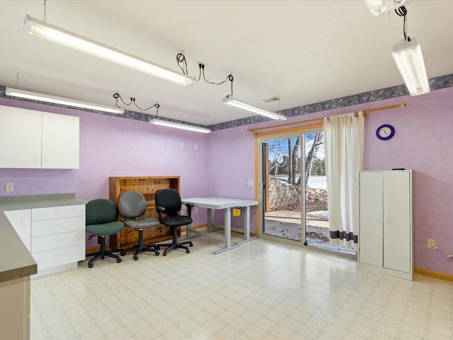 home office featuring light floors and baseboards