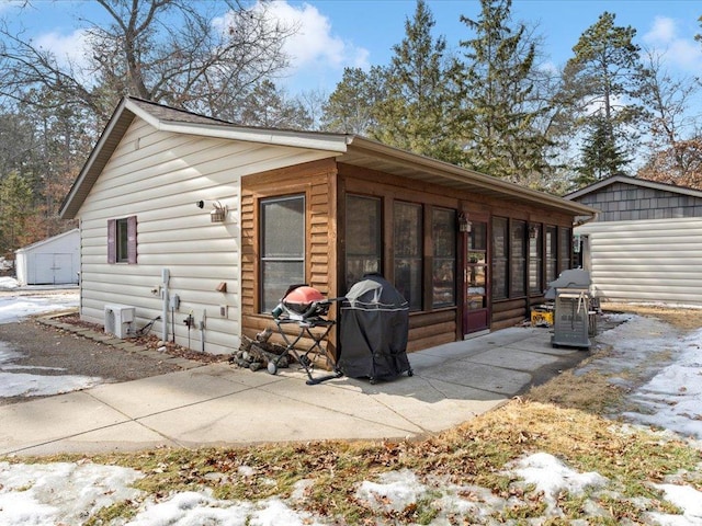 exterior space with a patio and a sunroom