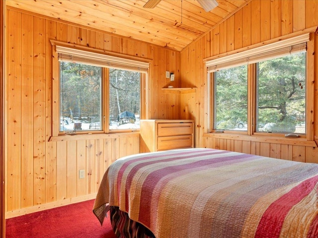 carpeted bedroom with vaulted ceiling, wood ceiling, and wood walls