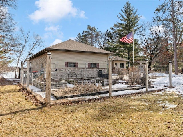 rear view of house with a garden and fence