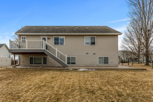 back of house with a yard, a patio, a shingled roof, and fence