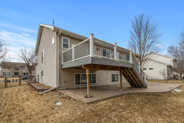 rear view of property featuring stairs, a patio, a deck, and fence