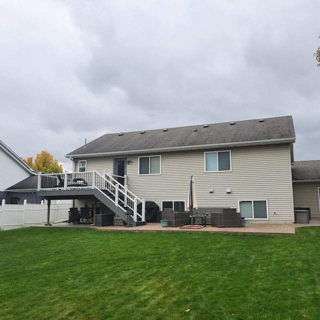 back of property with a wooden deck, a patio, stairs, fence, and a yard