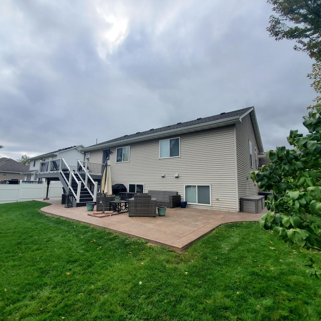 back of property featuring a patio, fence, stairway, a lawn, and a wooden deck