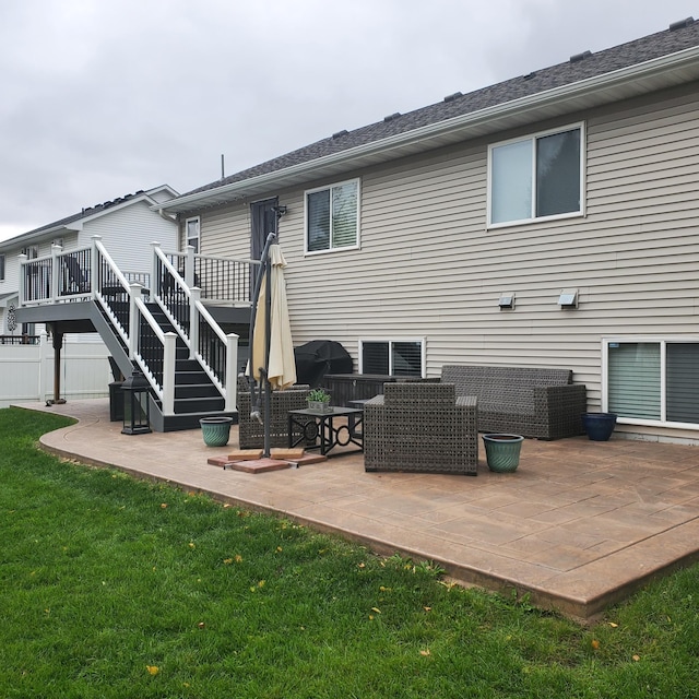 back of property with a patio, a yard, stairway, and a wooden deck