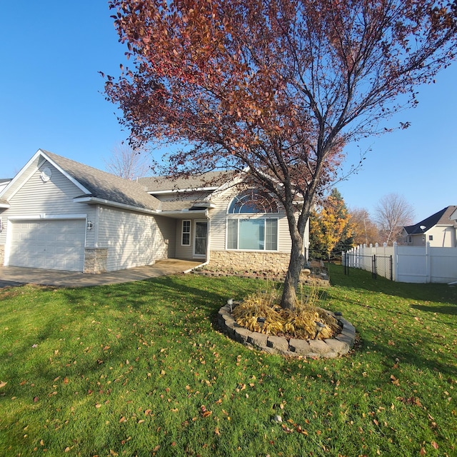 ranch-style house featuring a garage, stone siding, fence, and a front yard