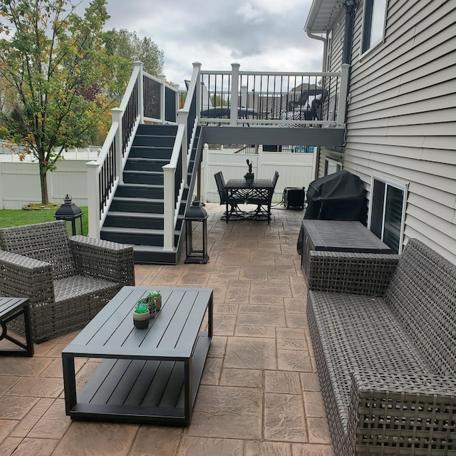 view of patio / terrace featuring fence, stairway, grilling area, and outdoor dining space