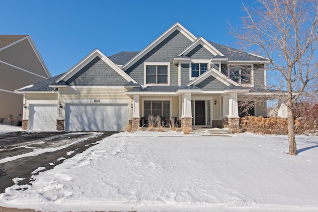 view of front of home featuring a garage and stone siding