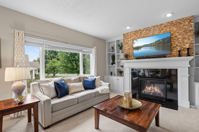 living room with a textured ceiling, a fireplace with flush hearth, light colored carpet, and built in features