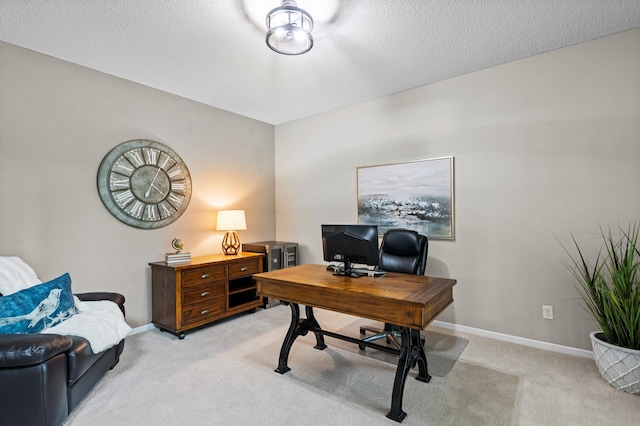 home office featuring light carpet, baseboards, and a textured ceiling