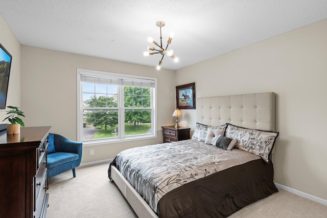 bedroom with light colored carpet, a notable chandelier, a textured ceiling, and baseboards